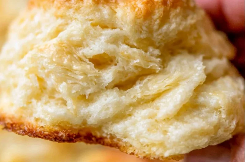 A tray of fluffy homemade biscuits fresh out of the oven.