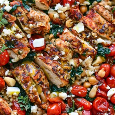 Plate of Greek Chicken with Lemon Rice garnished with herbs.