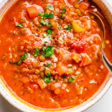 Bowl of Mediterranean Lentil Soup garnished with herbs and served with crusty bread