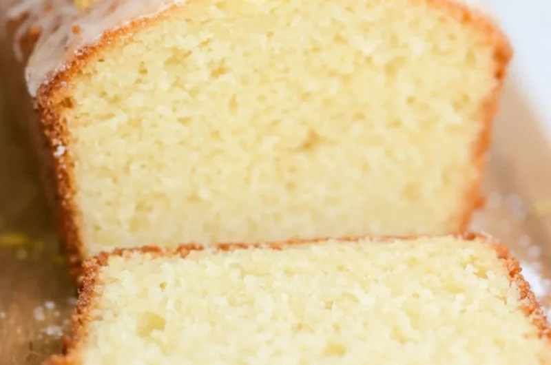 A beautiful slice of sourdough discard lemon cake on a white plate.